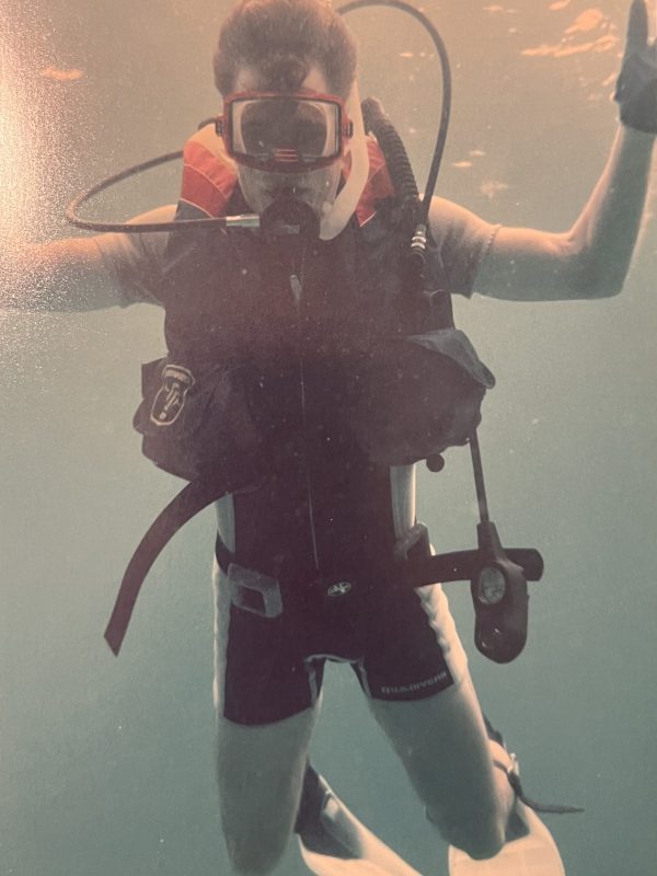 my brother David underwater in scuba gear holding his arms up